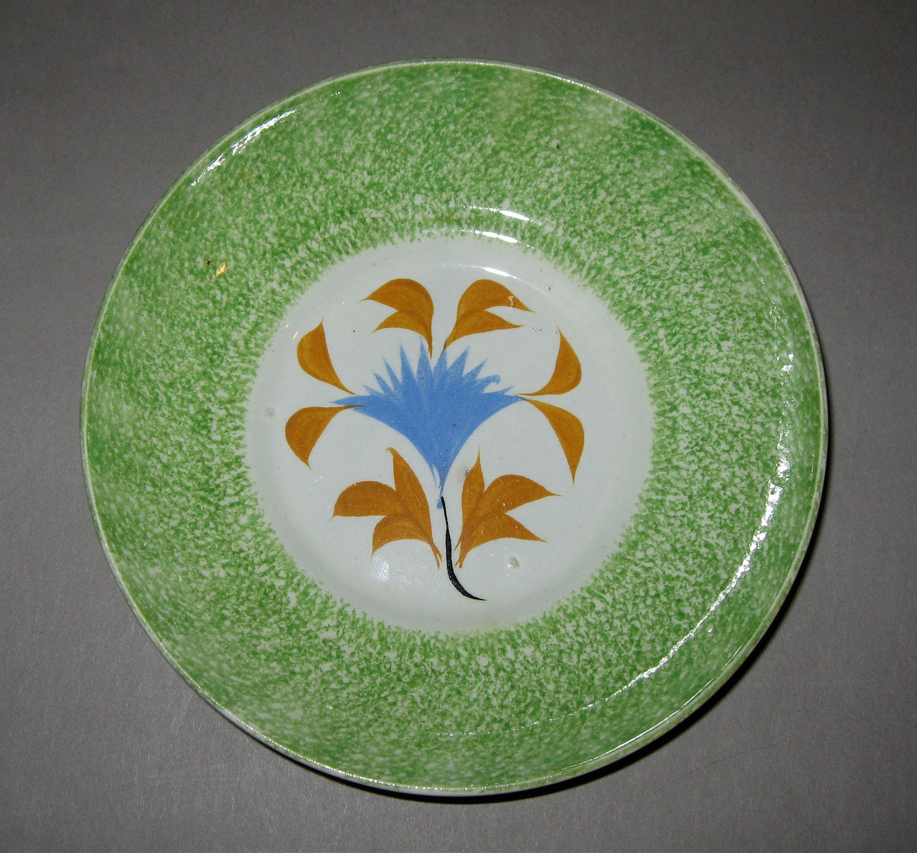 1965.0932 B Green spatterware cockscomb pattern saucer