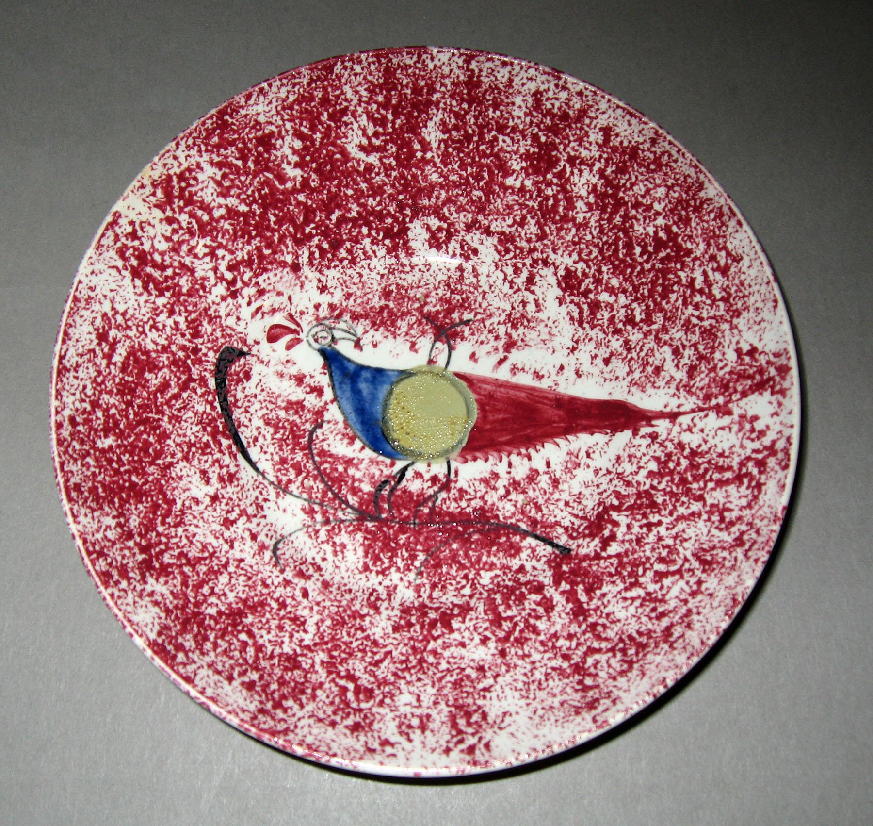 1965.0975.001 Pink spatterware saucer with peafowl pattern