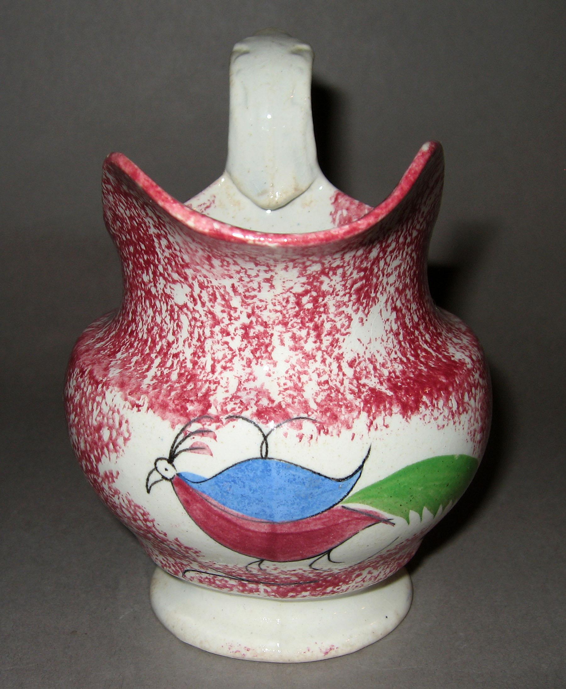 1965.1007 Pink spatterware peafowl cream jug