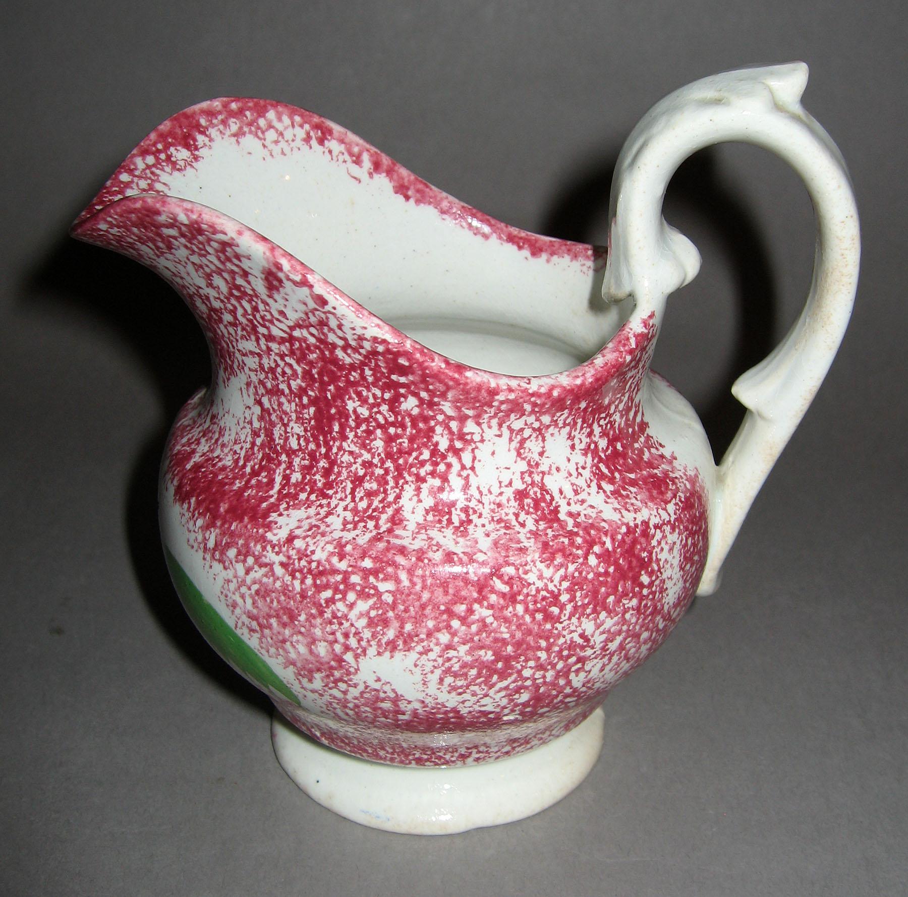 1965.1007 Pink spatterware peafowl cream jug (profile)