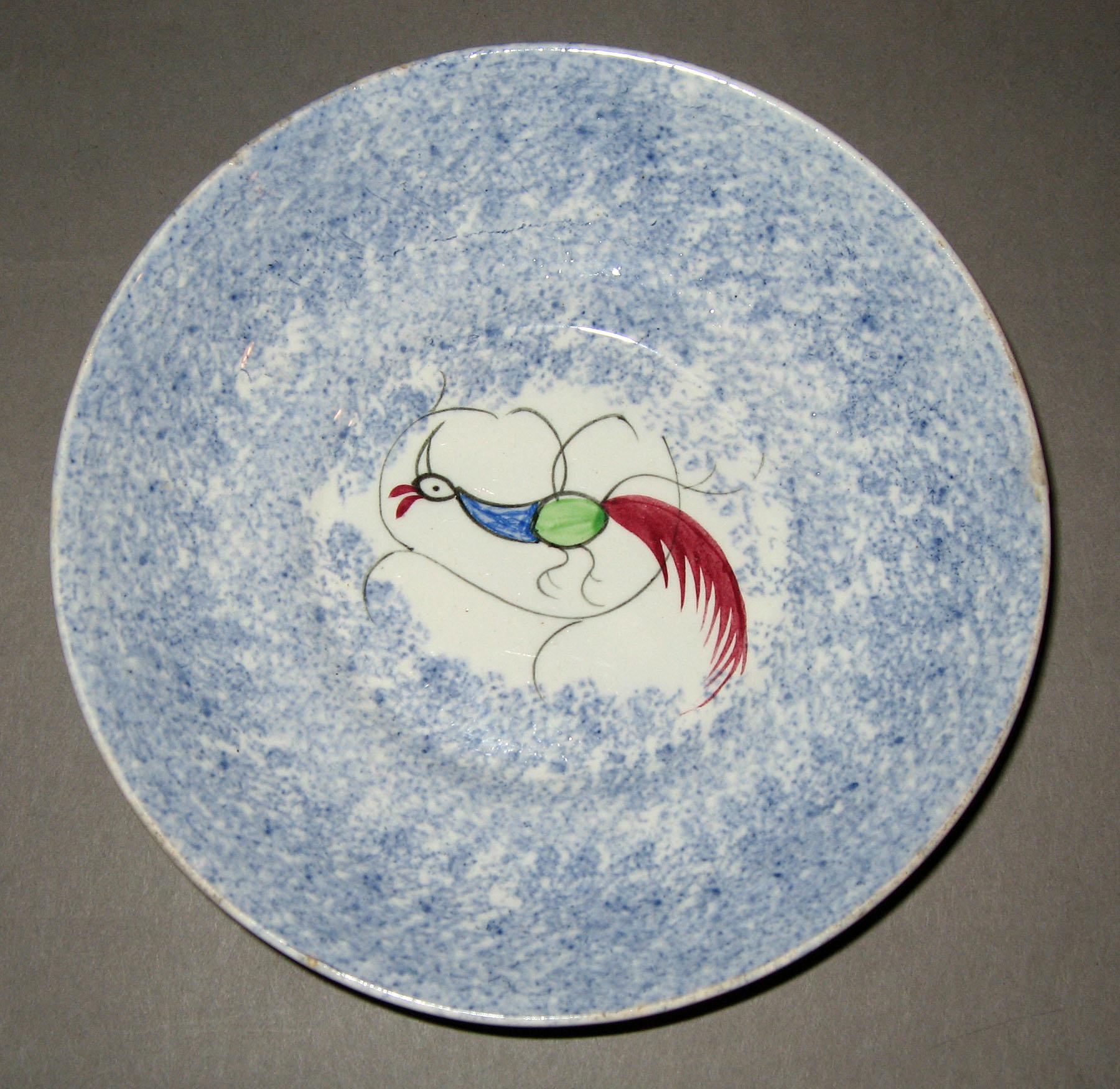 1965.1013 Blue spatterware peafowl saucer