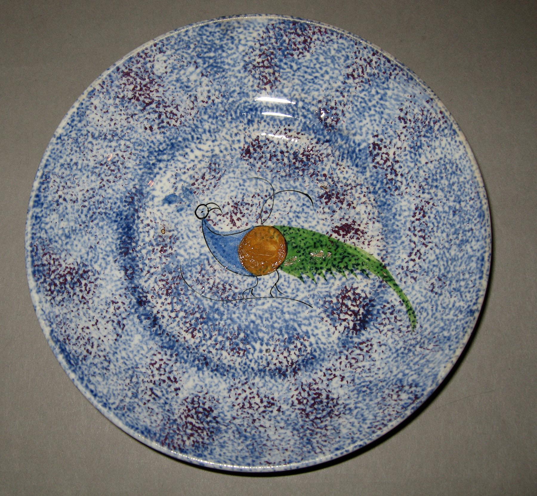 1965.1014 Blue and purple thumbprint spatterware saucer in a peafowl pattern