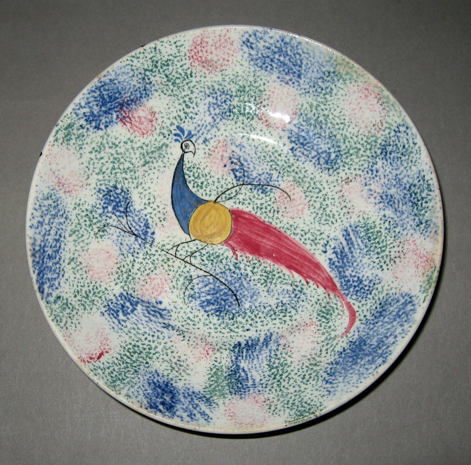 1965.1023.001 Rainbow thumbprint spatterware peafowl saucer