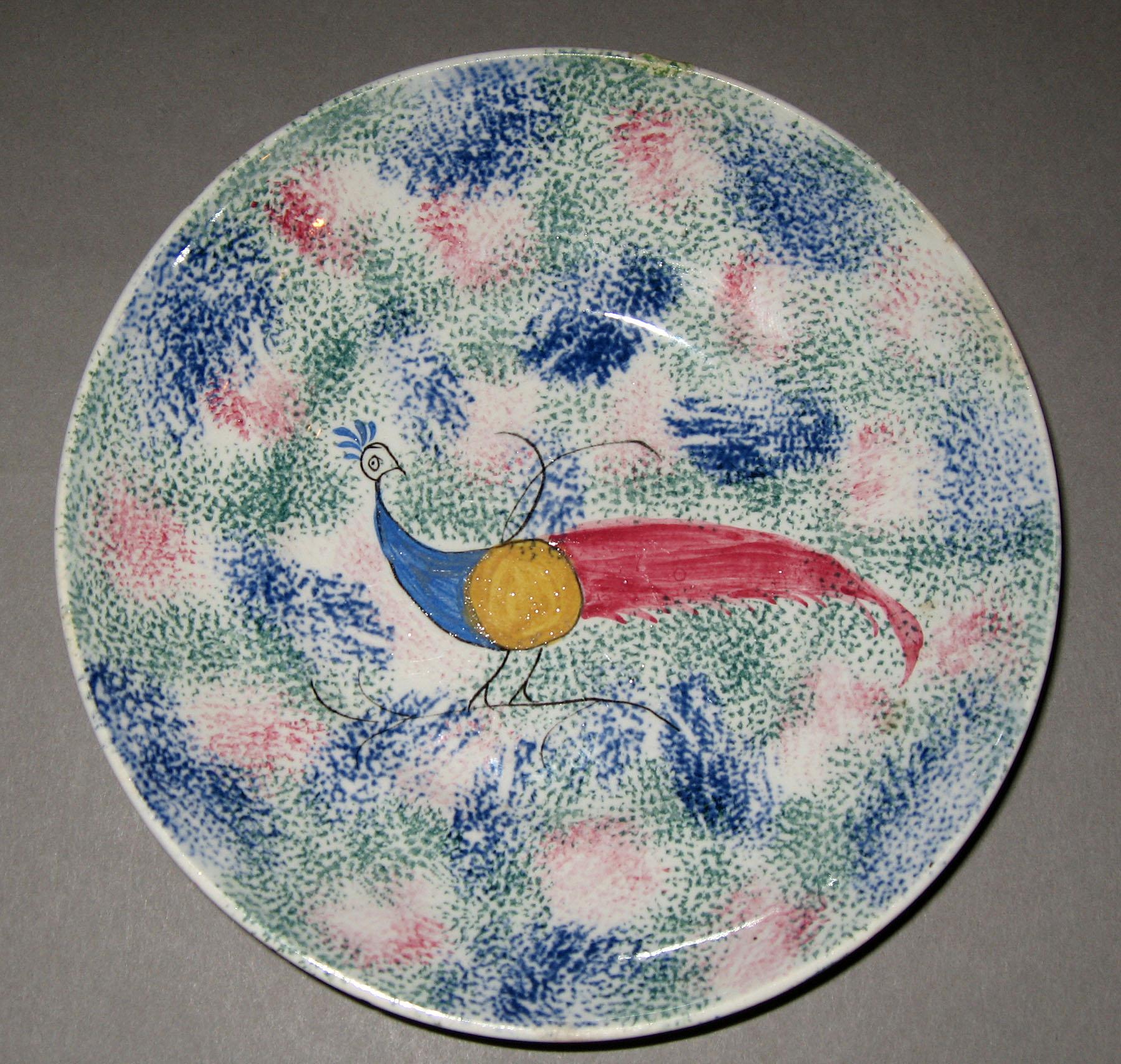 1965.1023.002 Thumbprint spatterware peafowl saucer