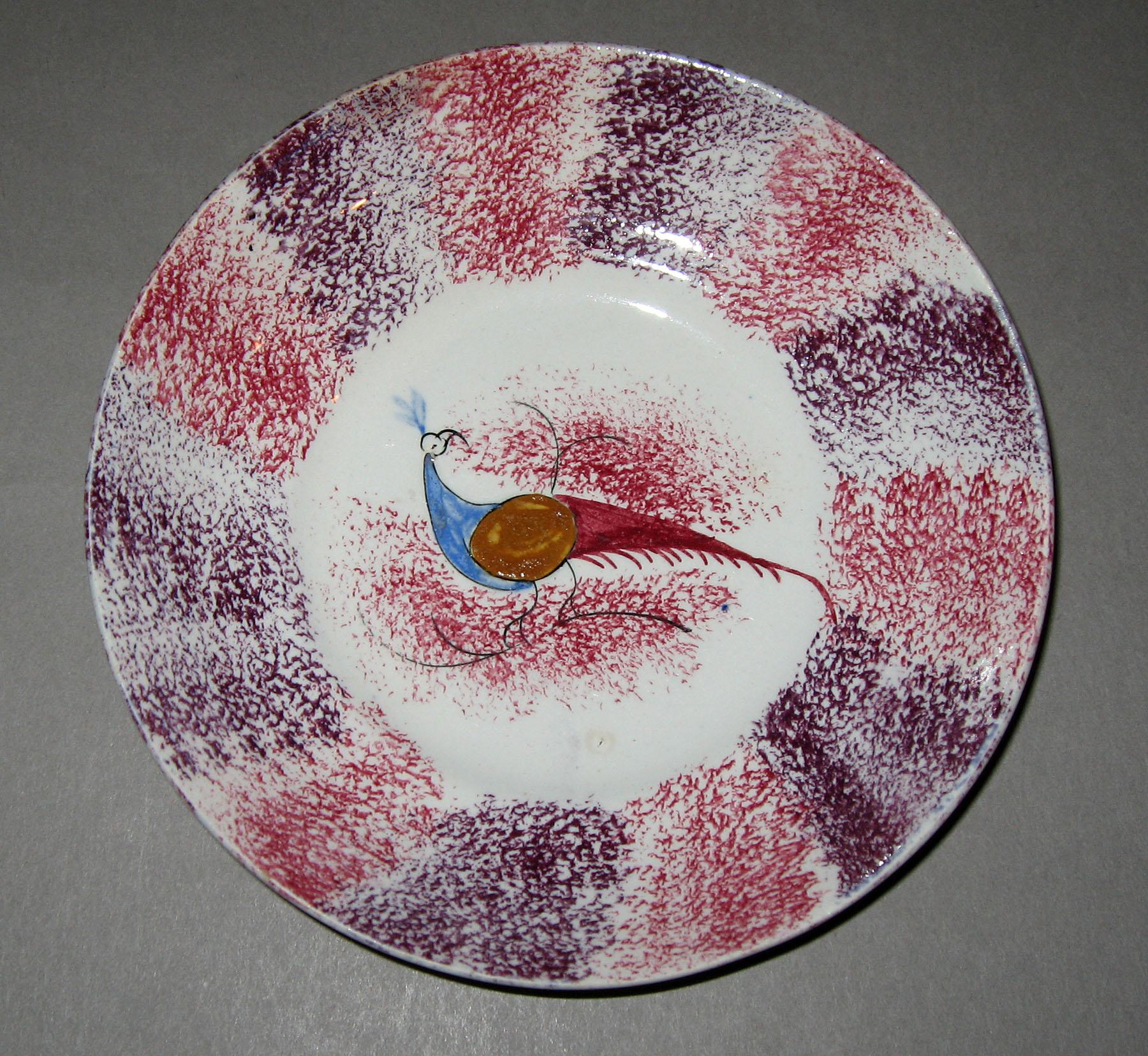 1965.1025 Rainbow spatterware peafowl saucer