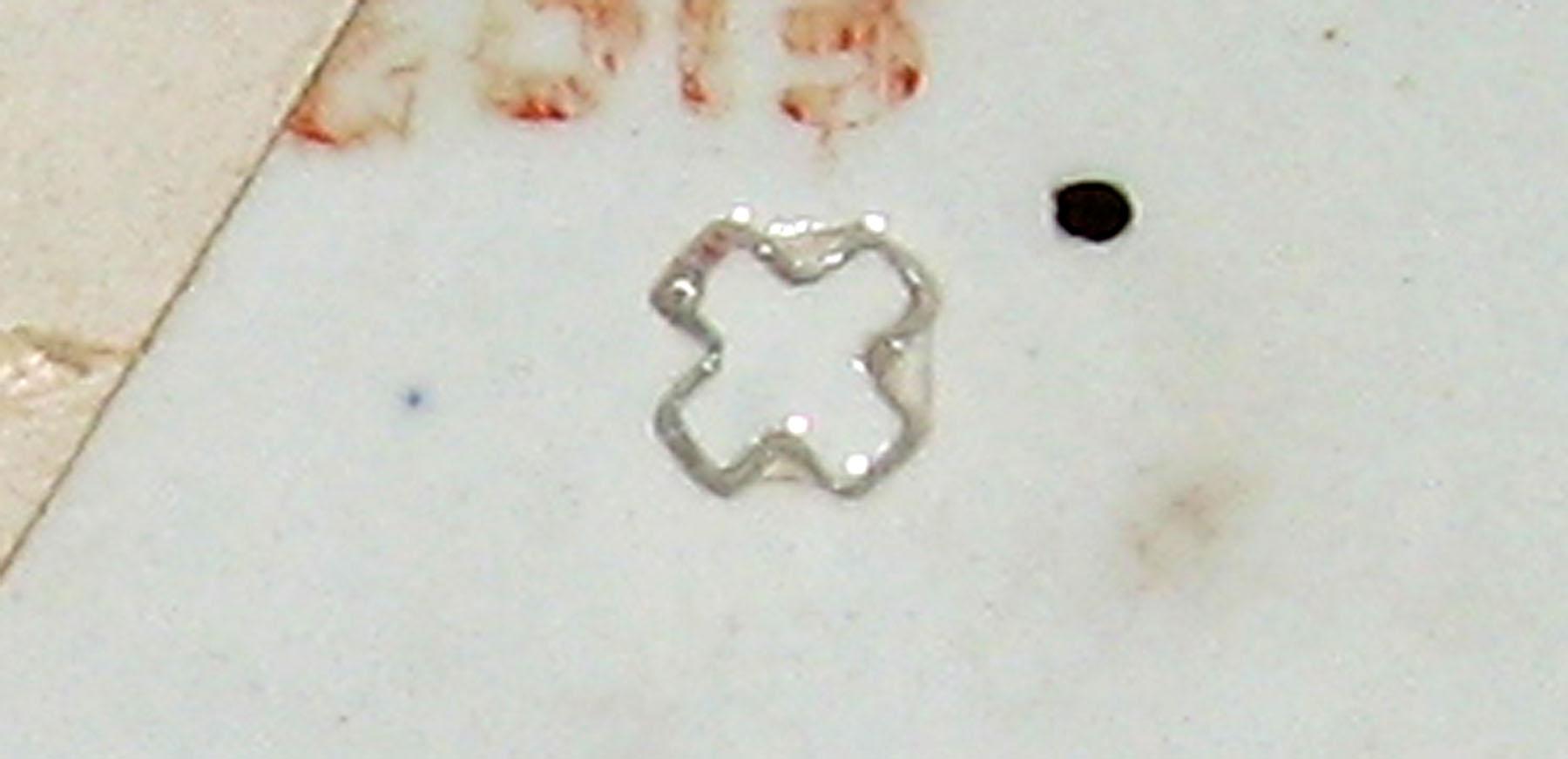 1965.1035 Red spatterware bird on a bar pattern saucer (mark)