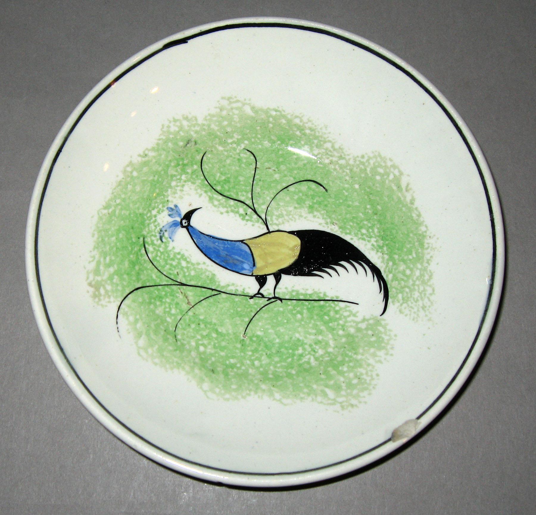 1965.1036.002 Green spatterware peafowl saucer