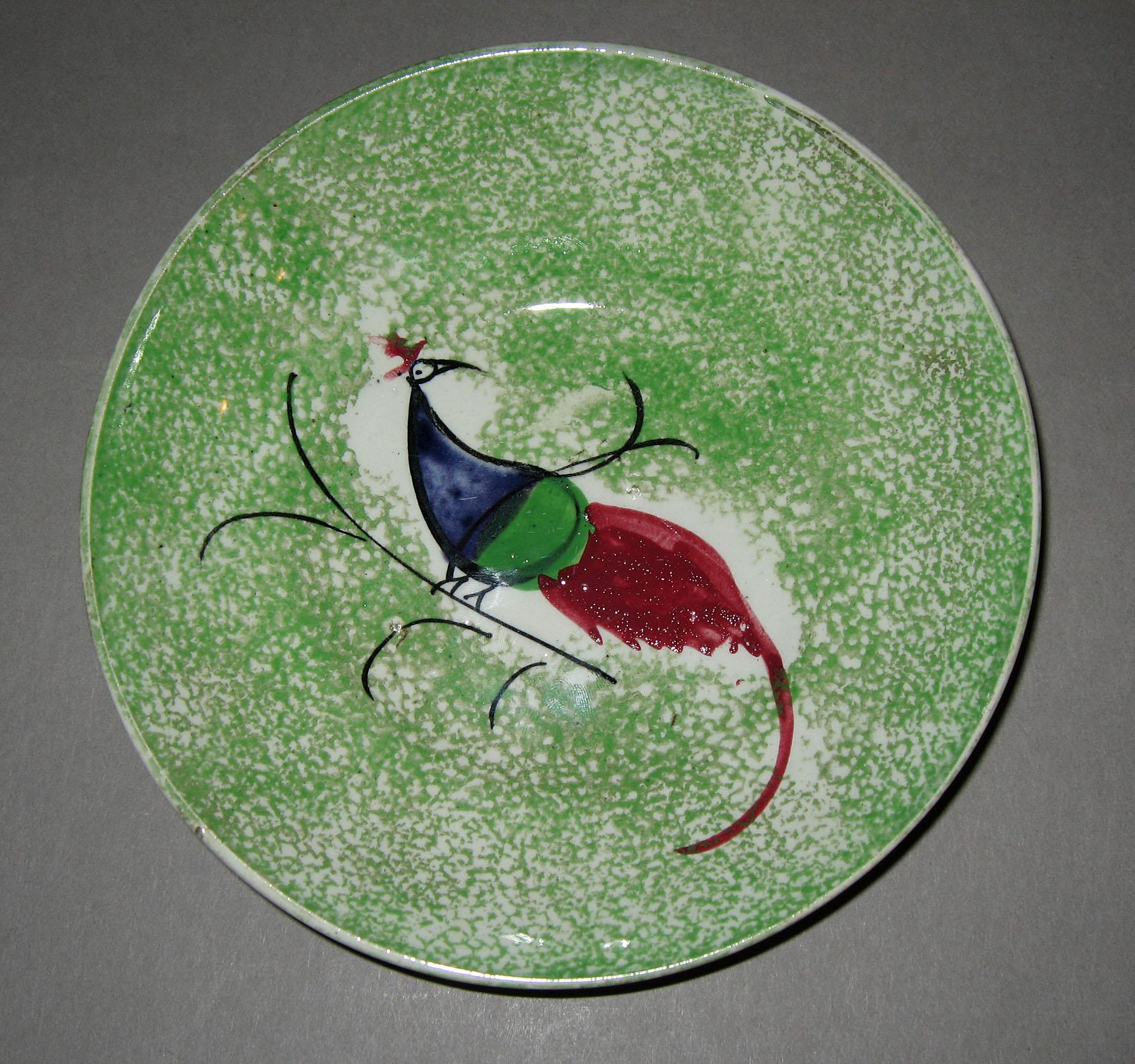 1965.1040 Green spatterware peafowl saucer
