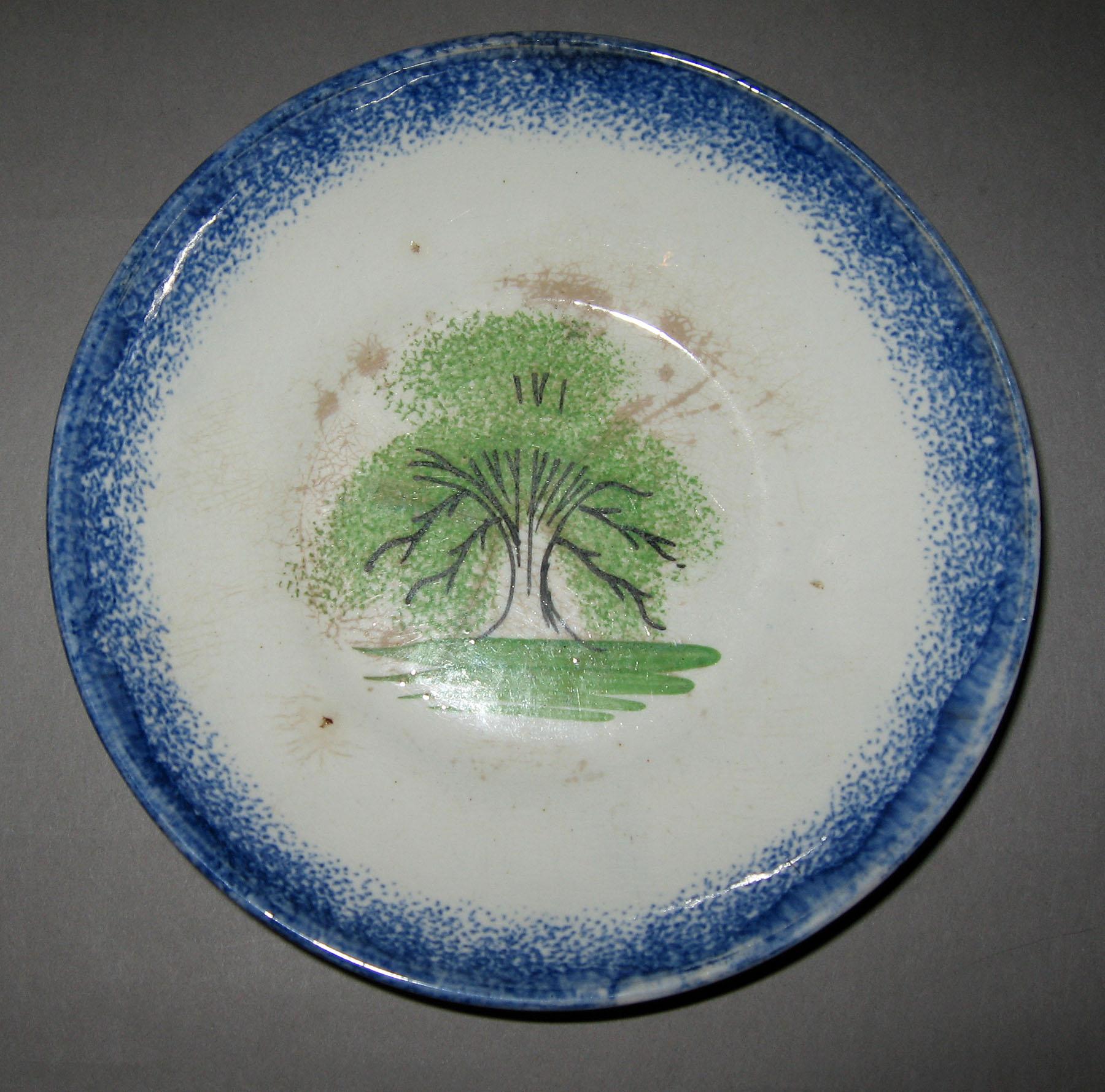 1965.1077 B Tree pattern with blue spatterware border saucer