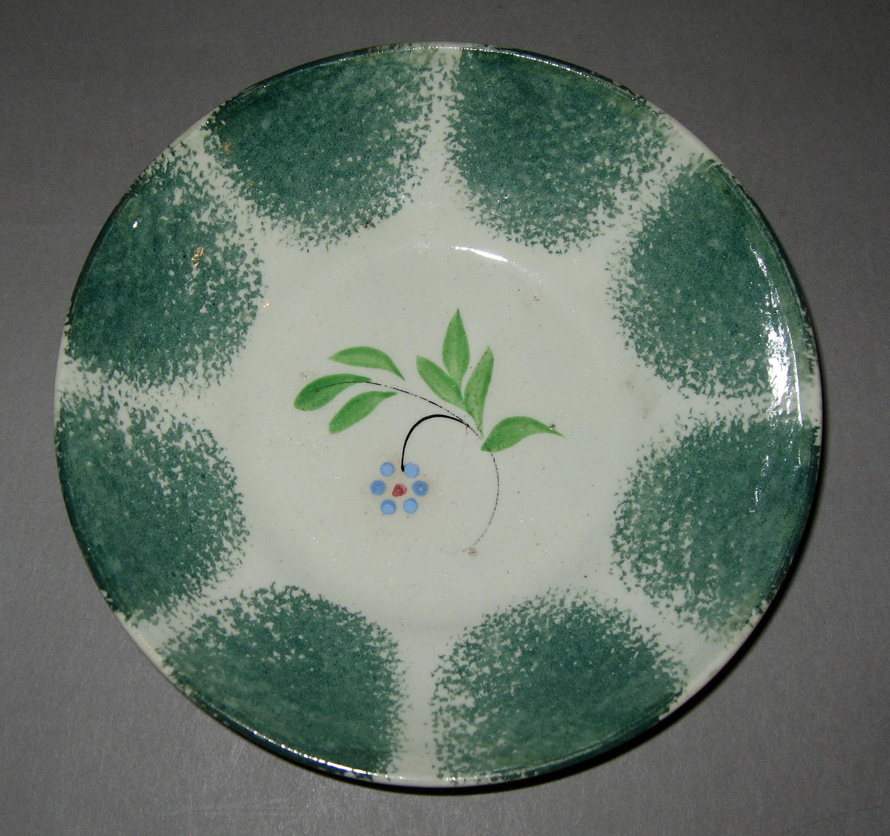 1965.1082.008 Teal spatterware saucer with "Forget-me-not" decoration