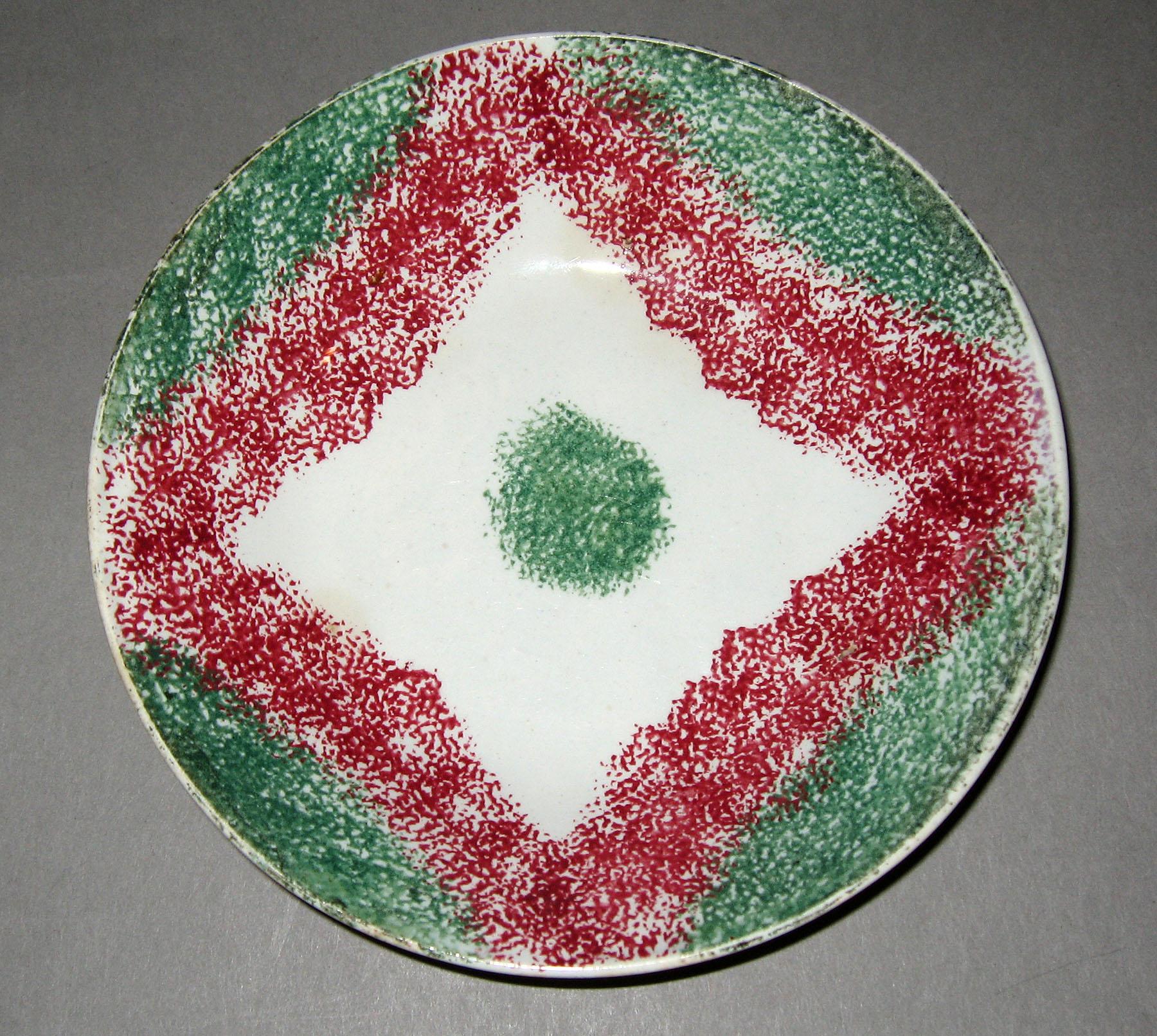 1965.1088 Pink and green drape spatterware saucer