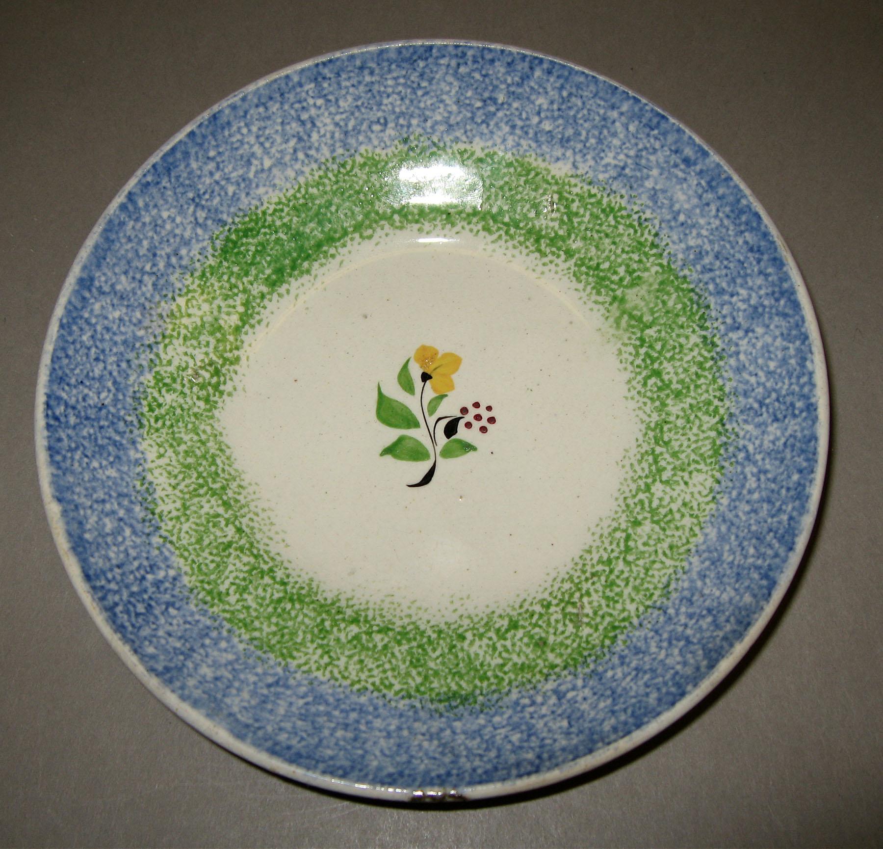 1965.1107.003 Rainbow and sprig spatter saucer