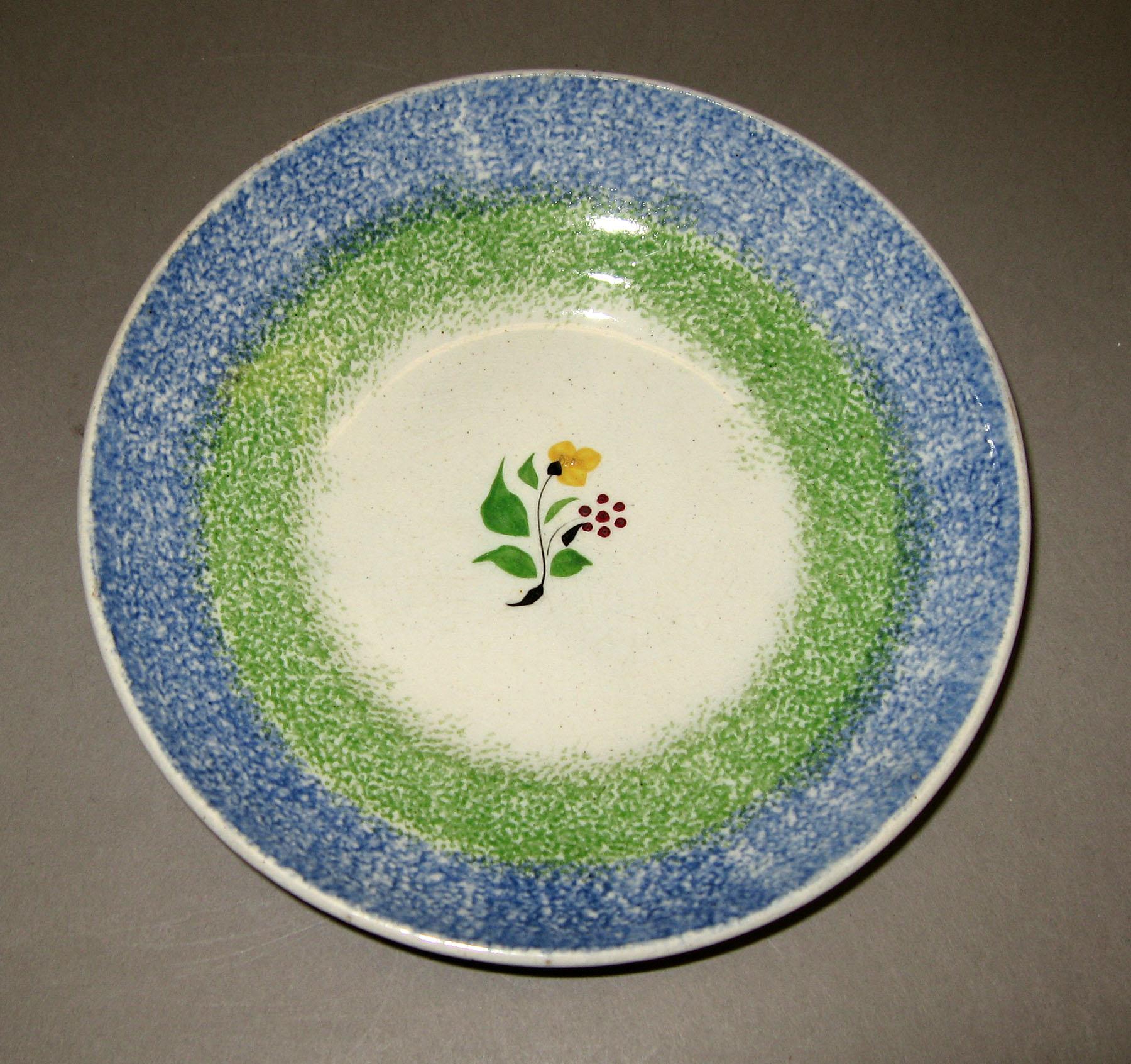 1965.1107.004 Rainbow and sprig saucer