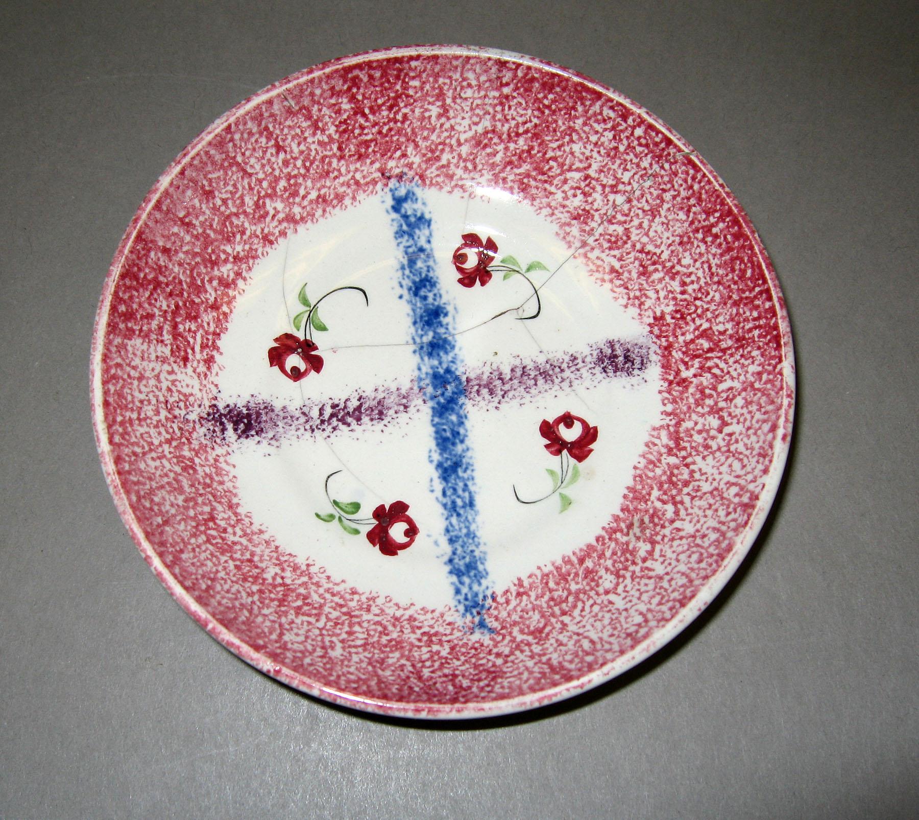 1965.1112 Red spatter criss-cross pattern saucer