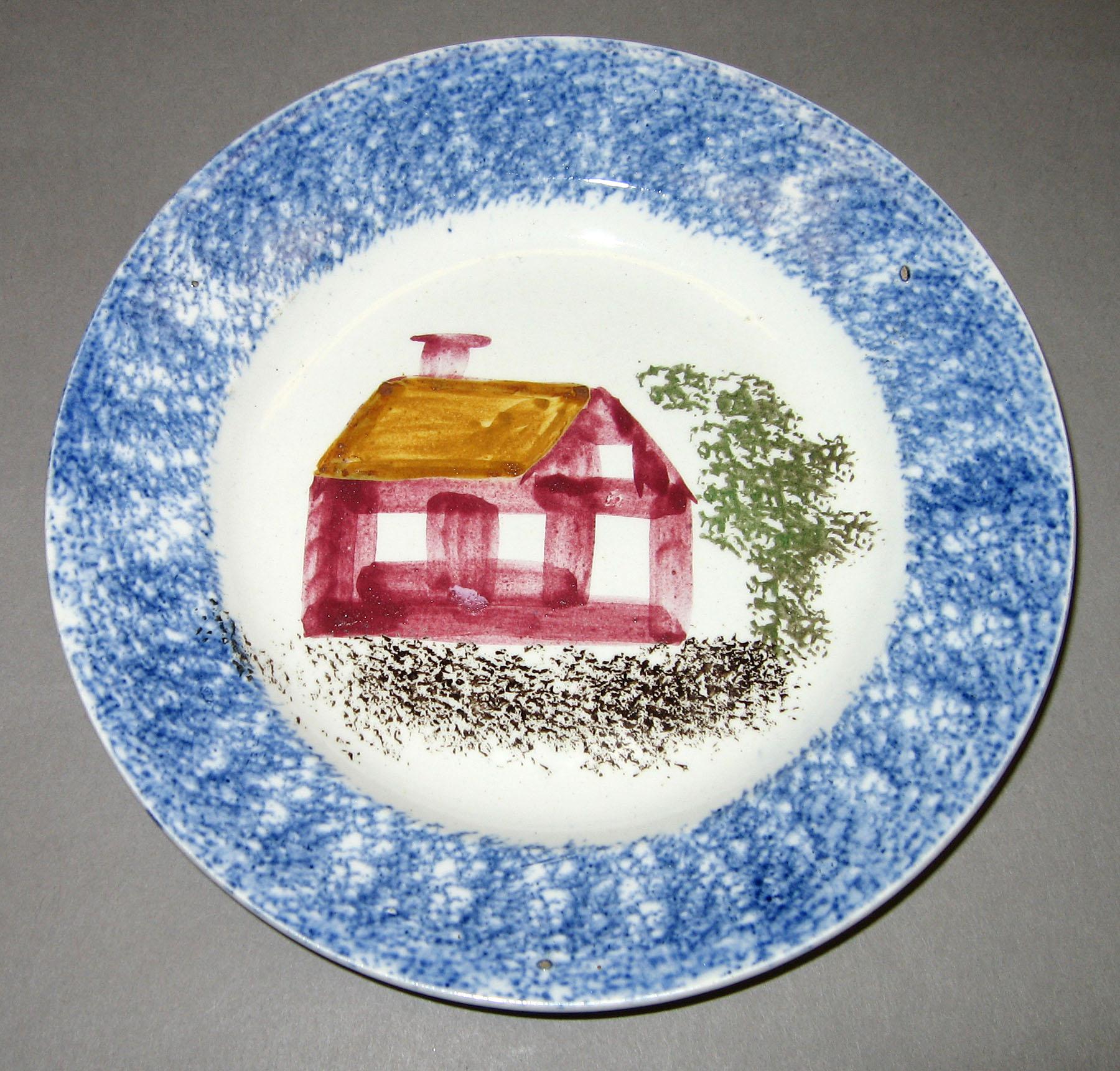 1965.1211.001 Blue spatter school house saucer