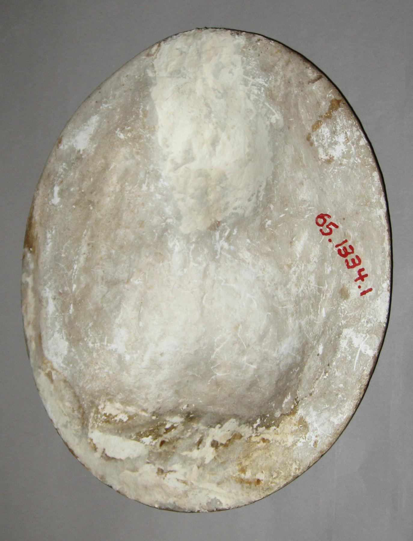 1965.1334.001 Chalkware male portrait plaque (back)