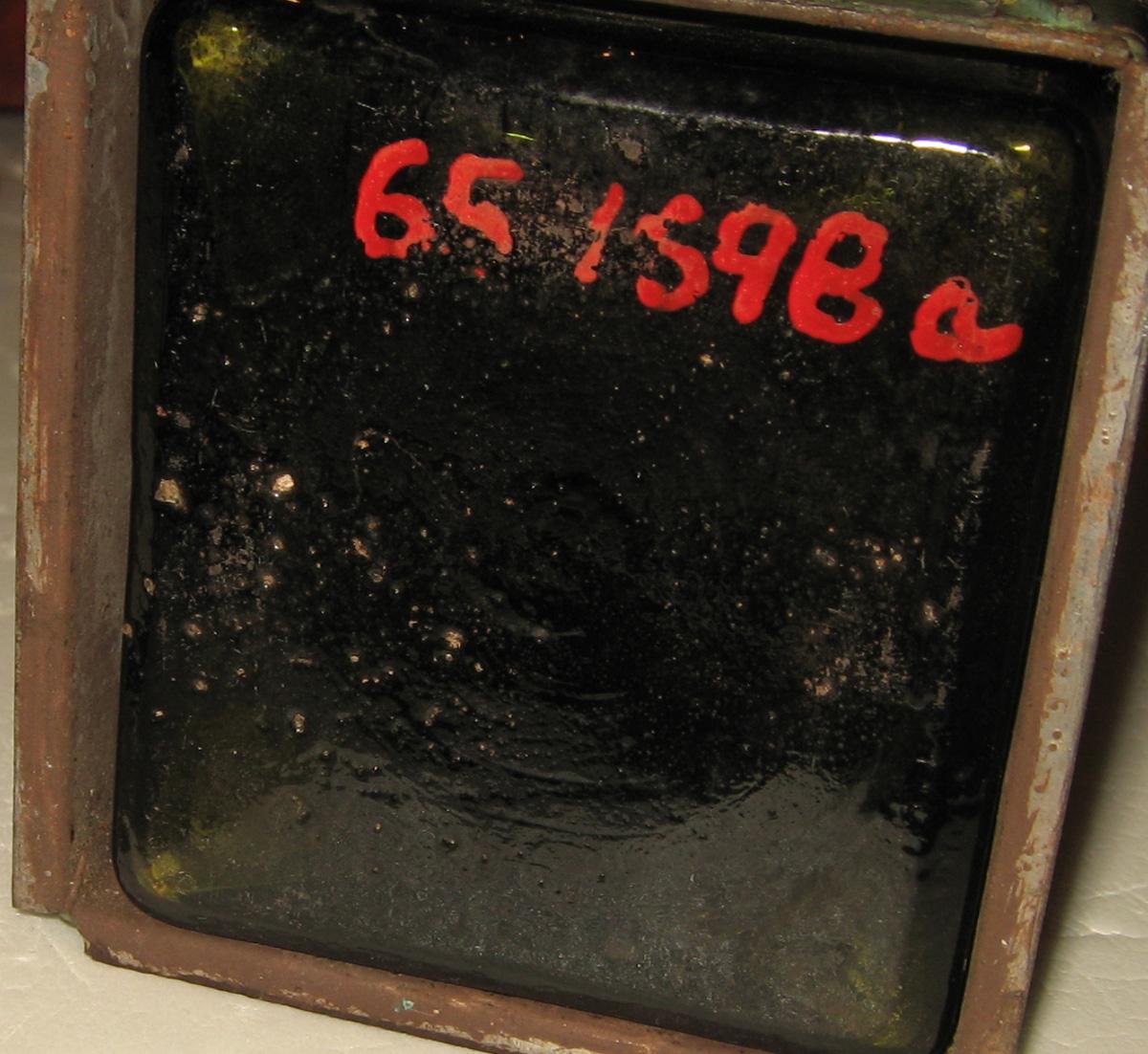 1965.1698 A Bottle in carrying case (underside)