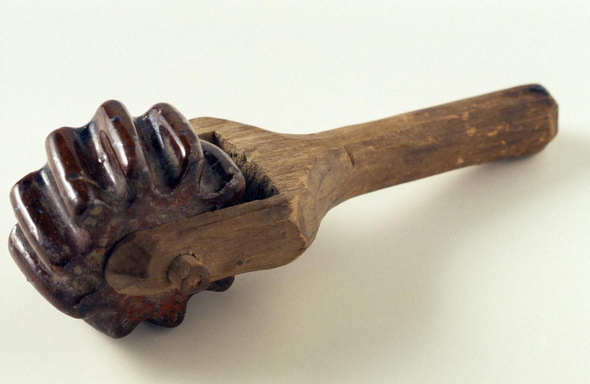 1965.1800 Redware and wood coggle wheel