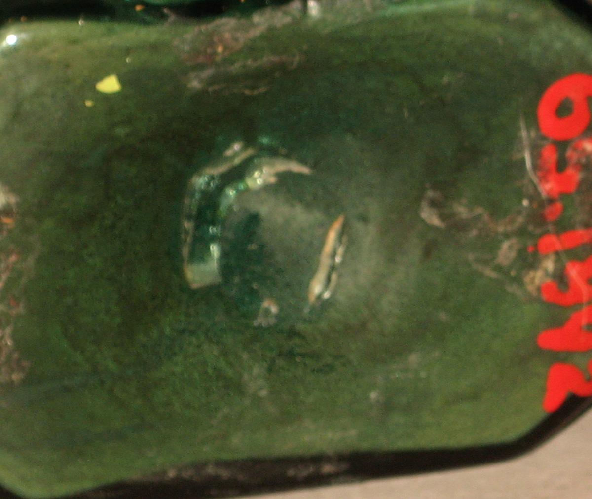 1965.1892 Glass bottle (underside)
