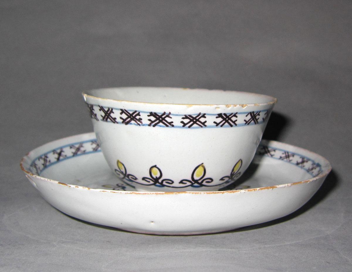 1966.0084 A,B Earthenware cup and saucer