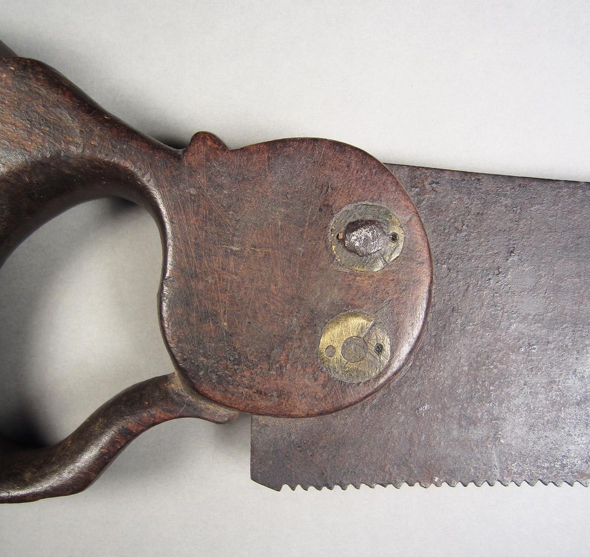 1957.0026.025, Hand saw, handle detail side 1