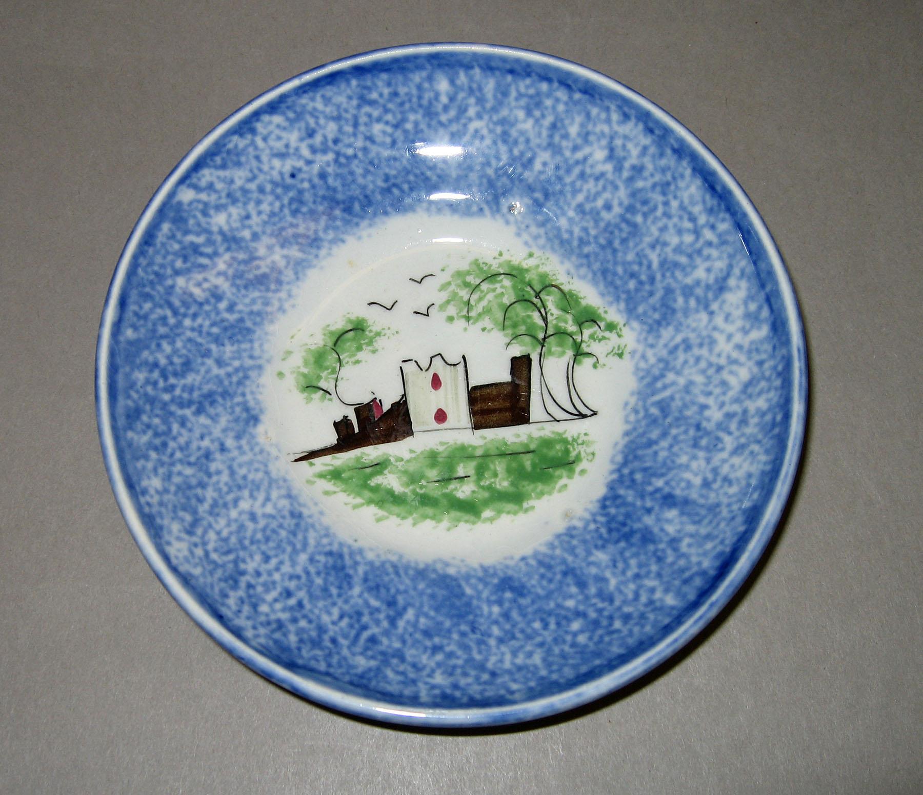 1966.1152.002 Fort or castle pattern blue spatterware saucer
