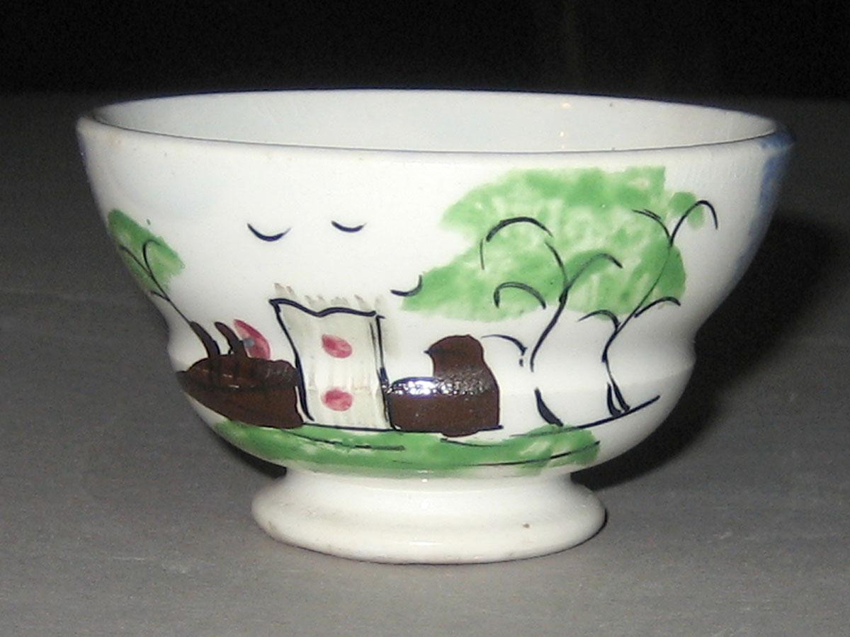 1966.1153.001 Fort or castle pattern blue spatterware teabowl