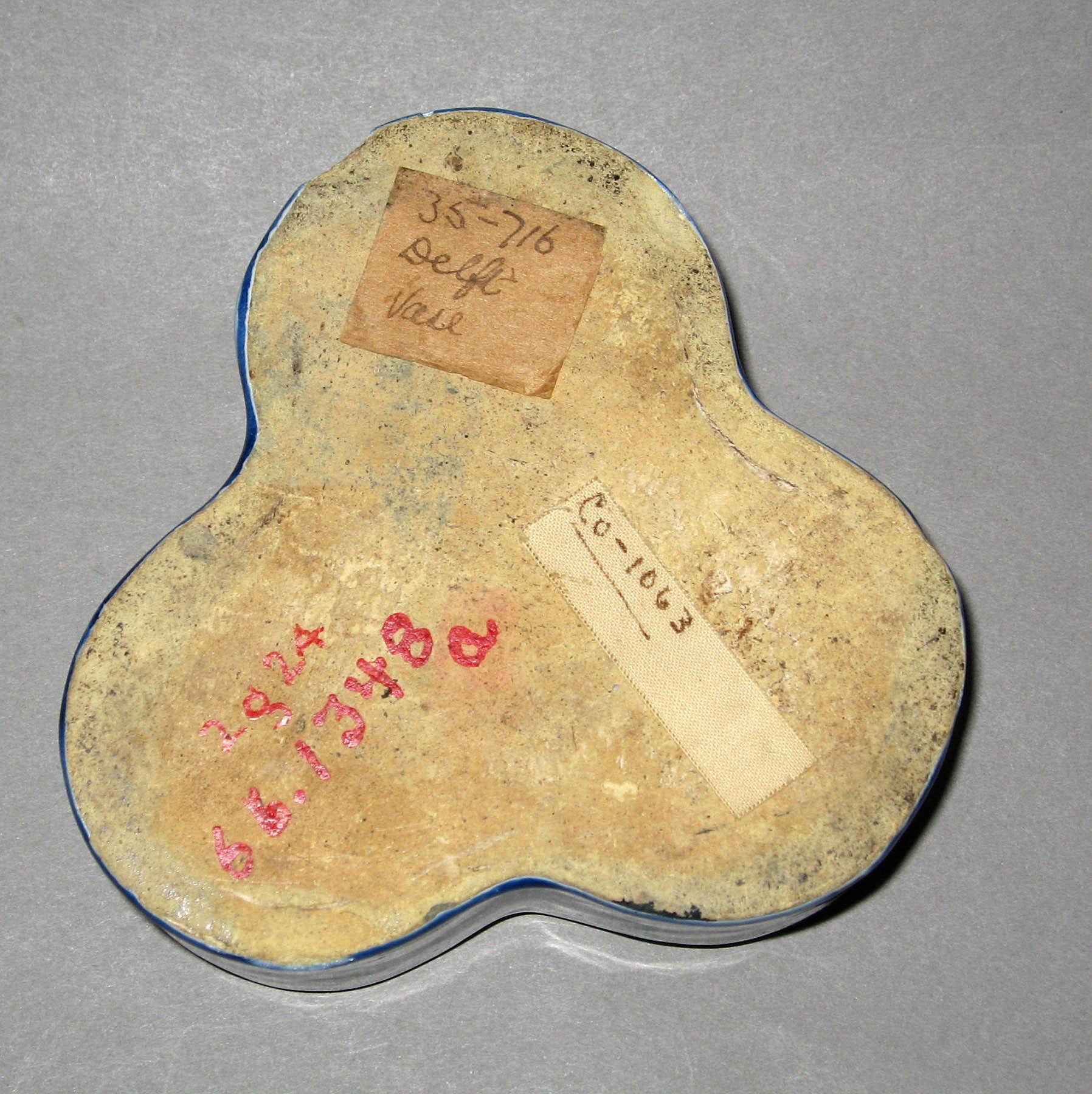 1966.1348 A, B Tin-glazed earthenware inkwell (underside)