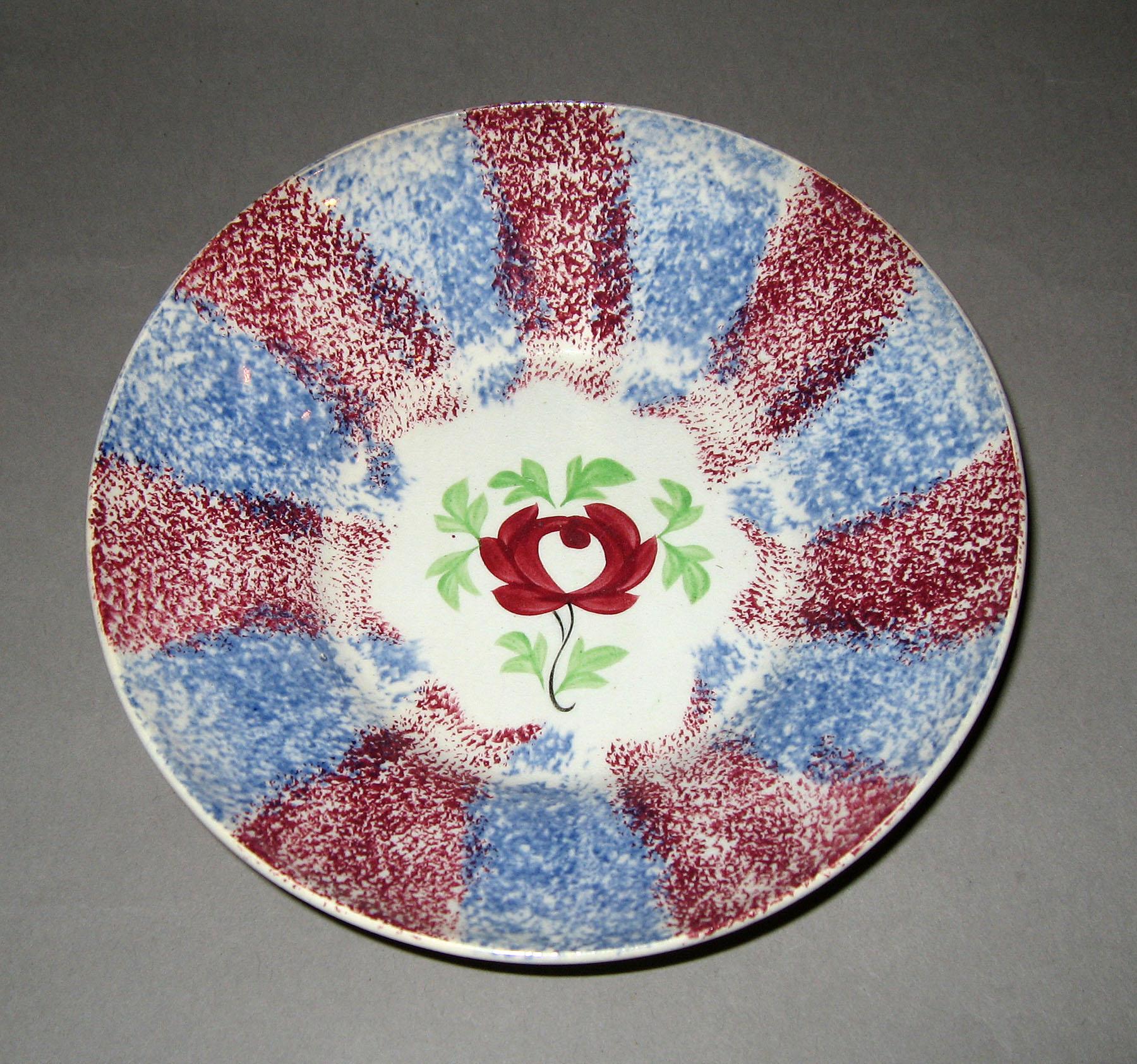1967.0135 B Blue spatterware and adams rose pattern saucer