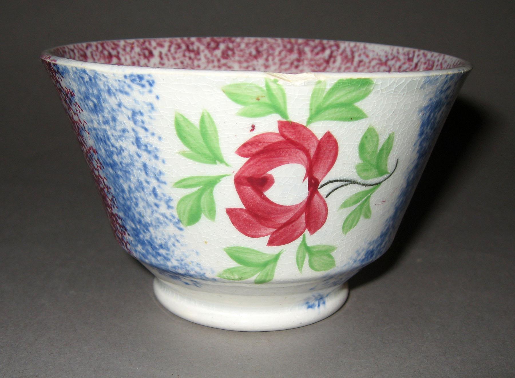 1967.0136 A Blue spatterware and adams rose pattern teabowl