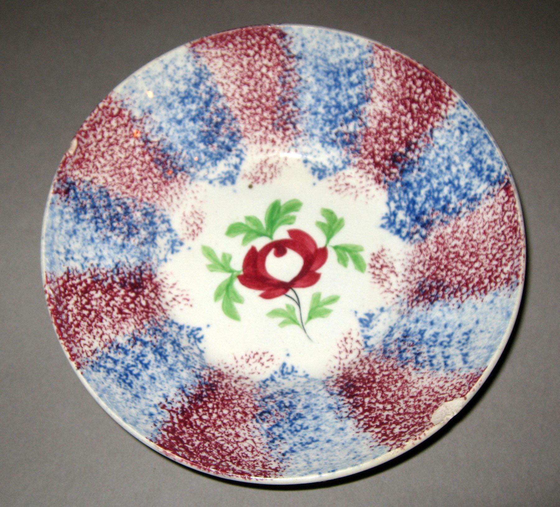 1967.0136 B Blue spatterware and adams rose pattern saucer