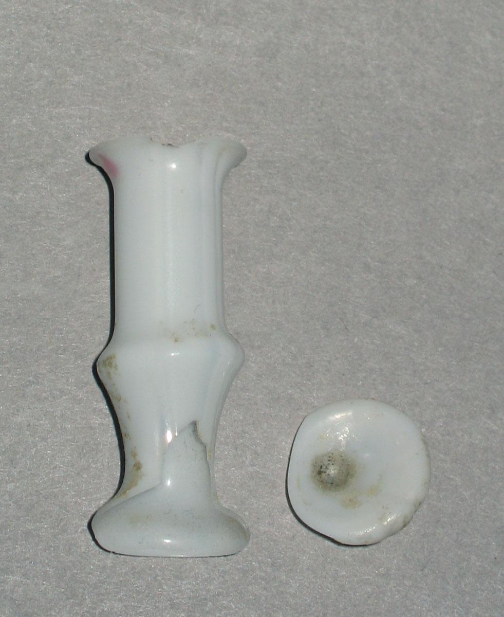 1967.0589 White glass miniature vase