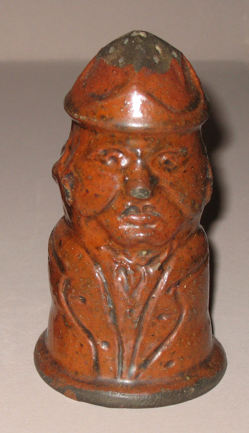 1967.1568 Redware man-shaped caster