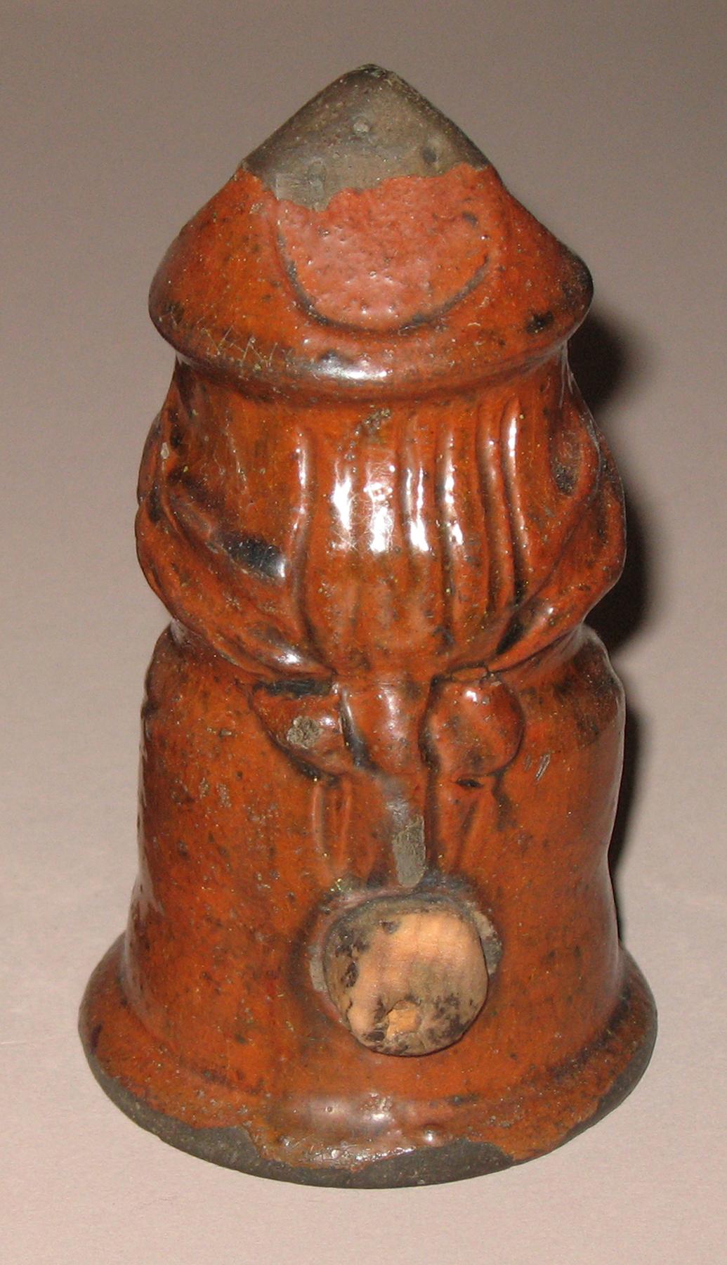 1967.1568 Redware man-shaped caster (back)