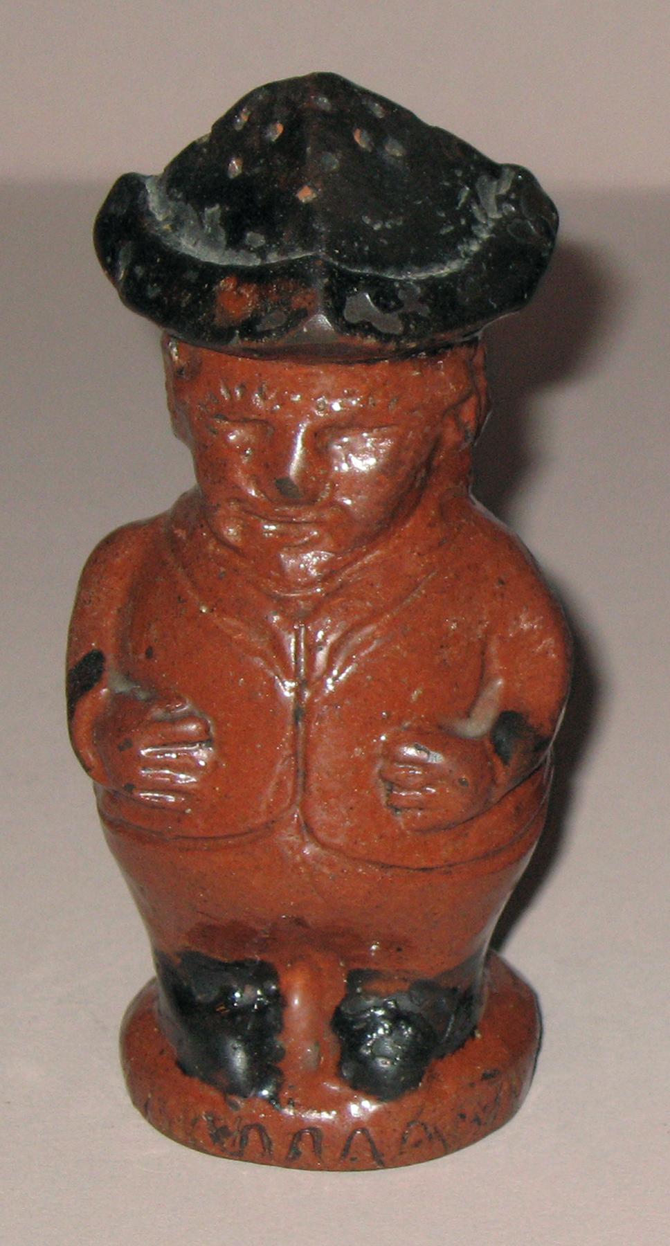 1967.1564 Redware man-shaped caster