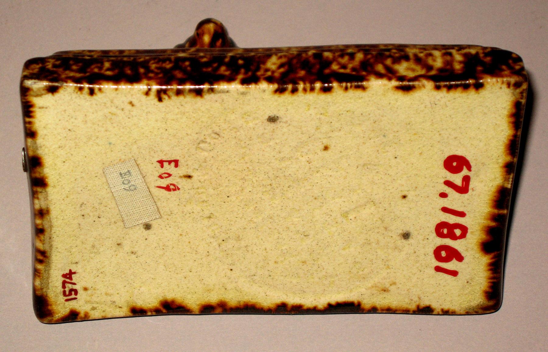 1967.1861 Earthenware dog  on cushion (bottom-mark)