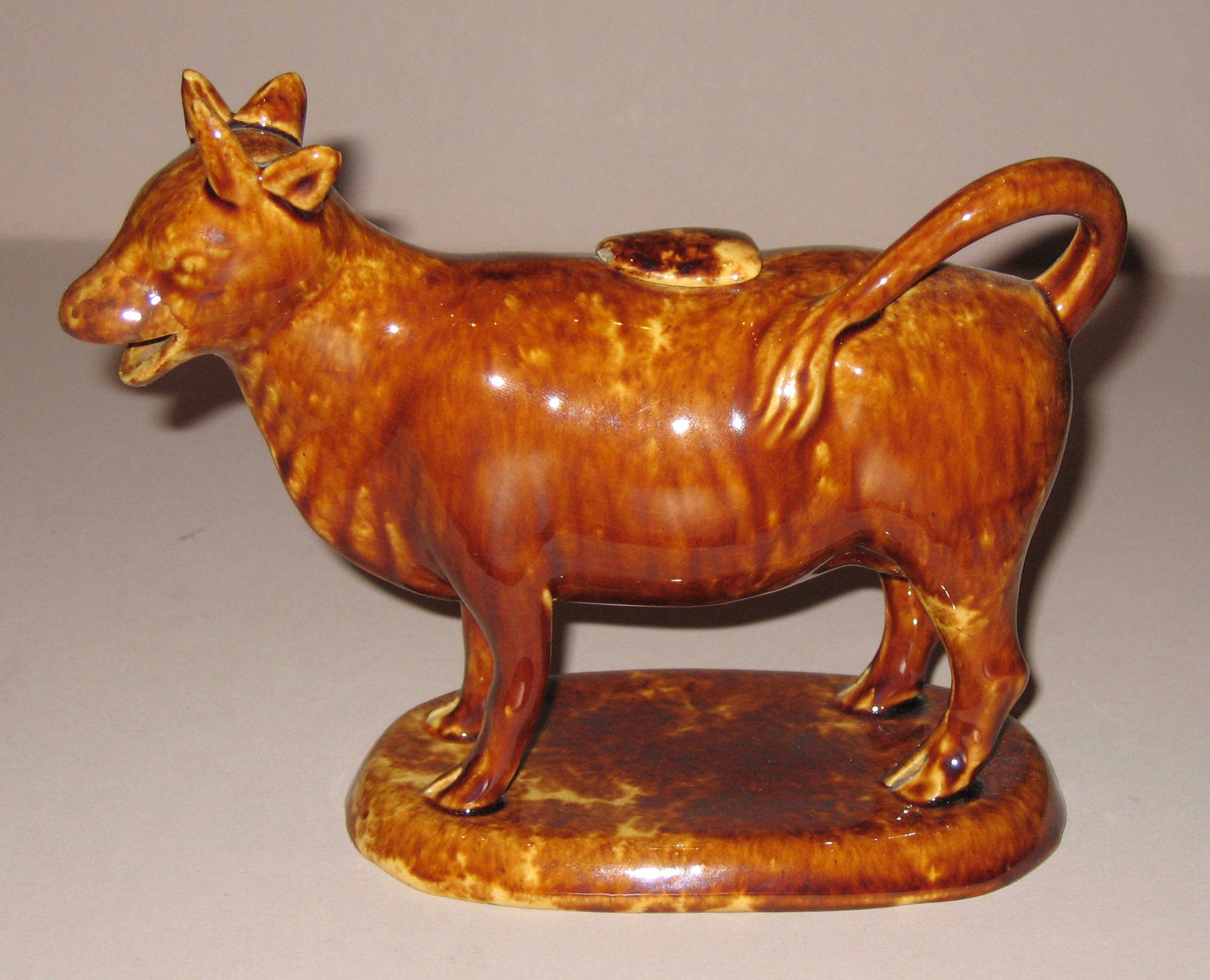 1967.1869 A, B Earthenware cow creamer