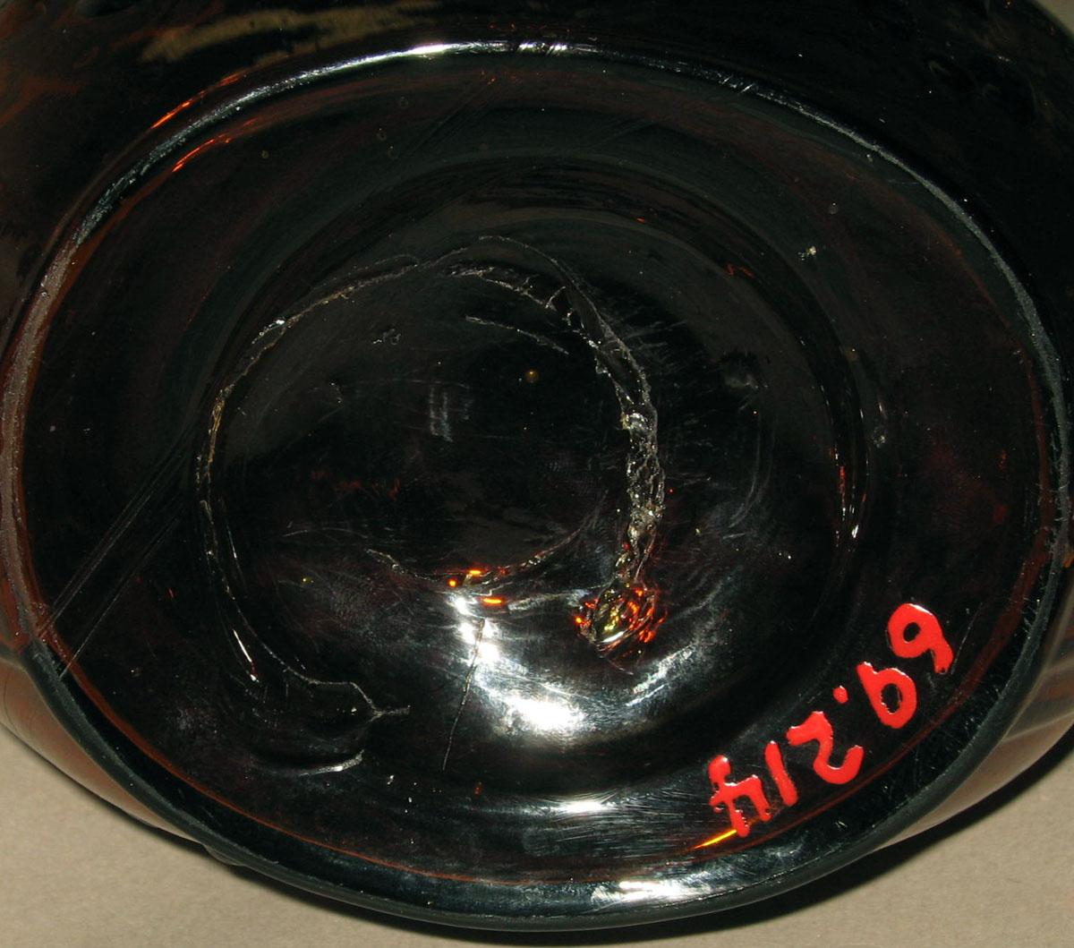 1969.0214 Glass bottle (underside)