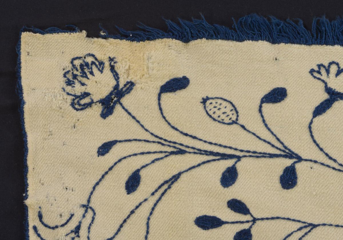 1969.0558 Bedcover, detail 2, before conservation treatment
