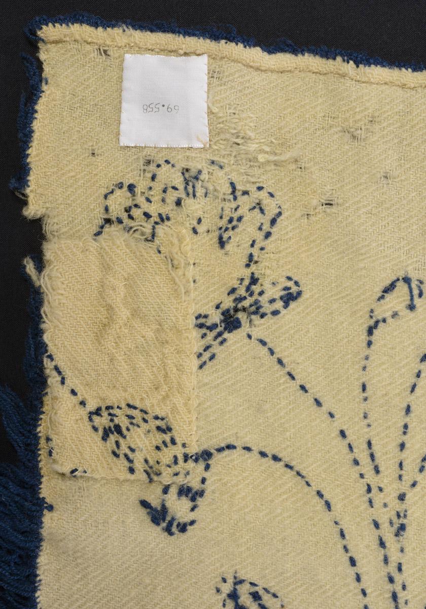 1969.0558 Bedcover, reverse, detail 2, before conservation treatment