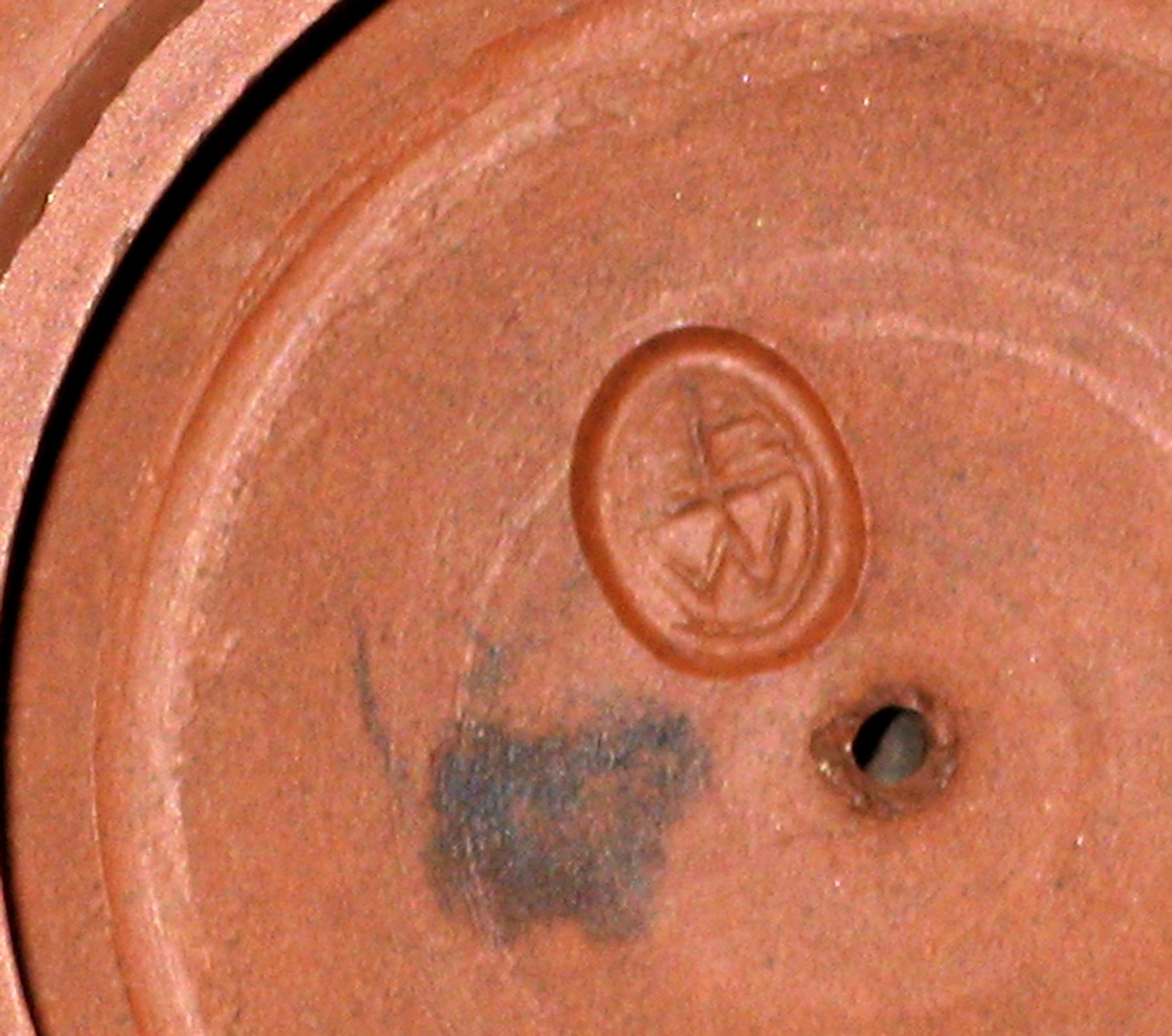 1969.2016 Unglazed redware teapot lid (mark)
