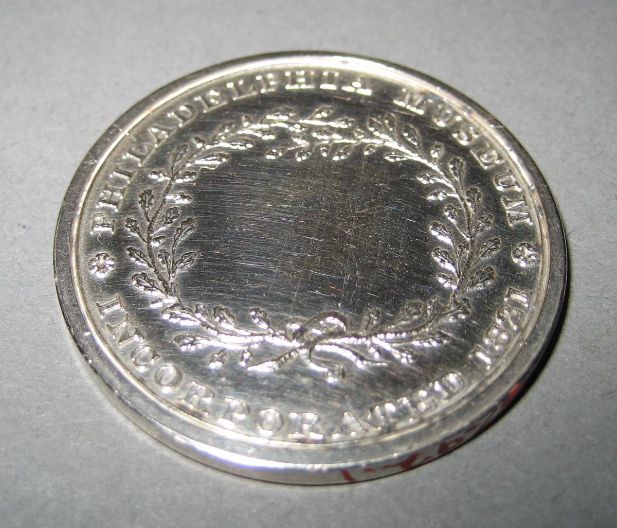 1957.0092.001 Admission token (reverse)