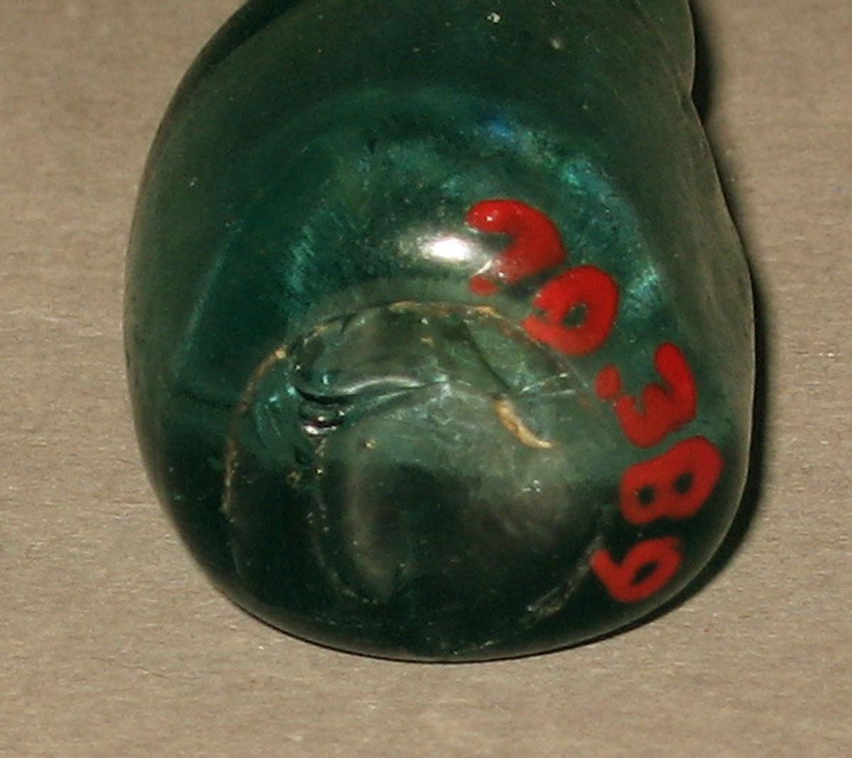 1970.0389 Miniature glass bottle (underside)