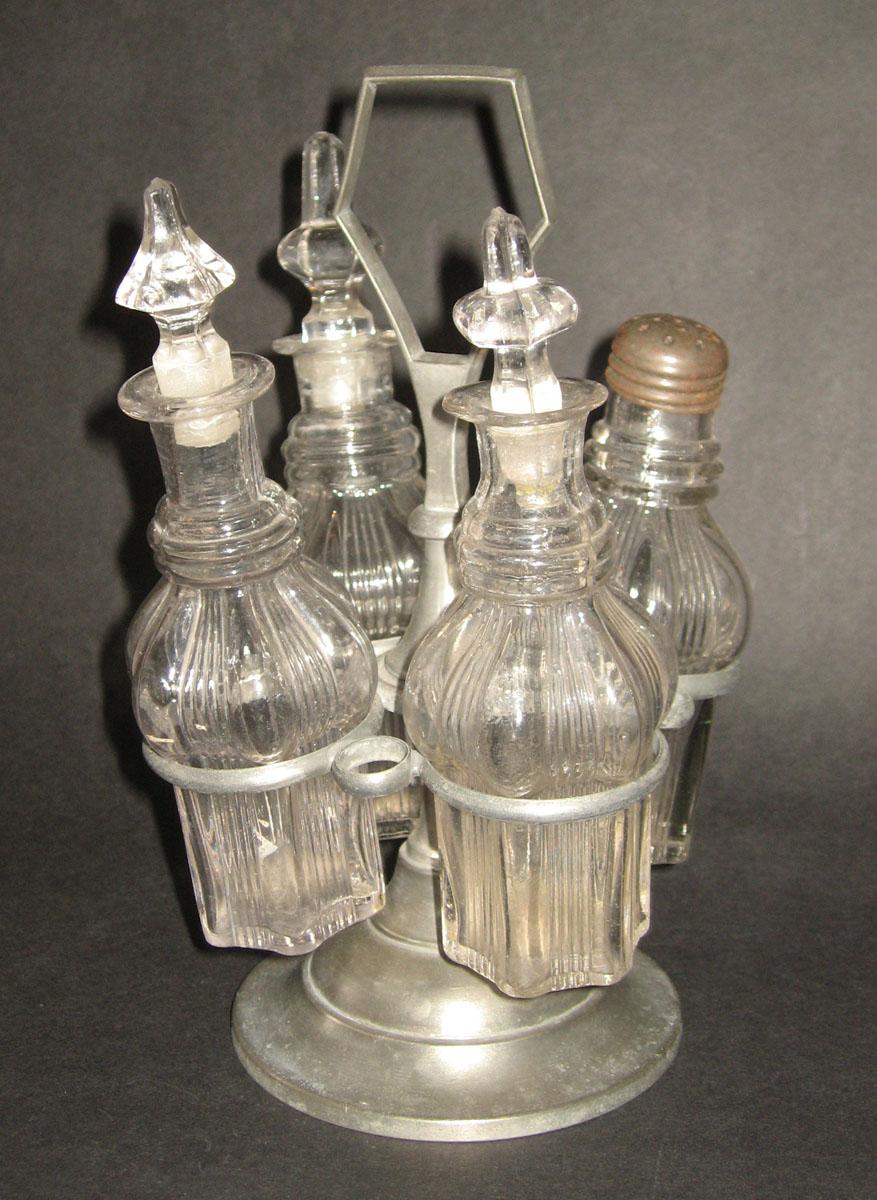 1971.0133.001-.004, 1971.0035 Glass cruets and castors and metal stand