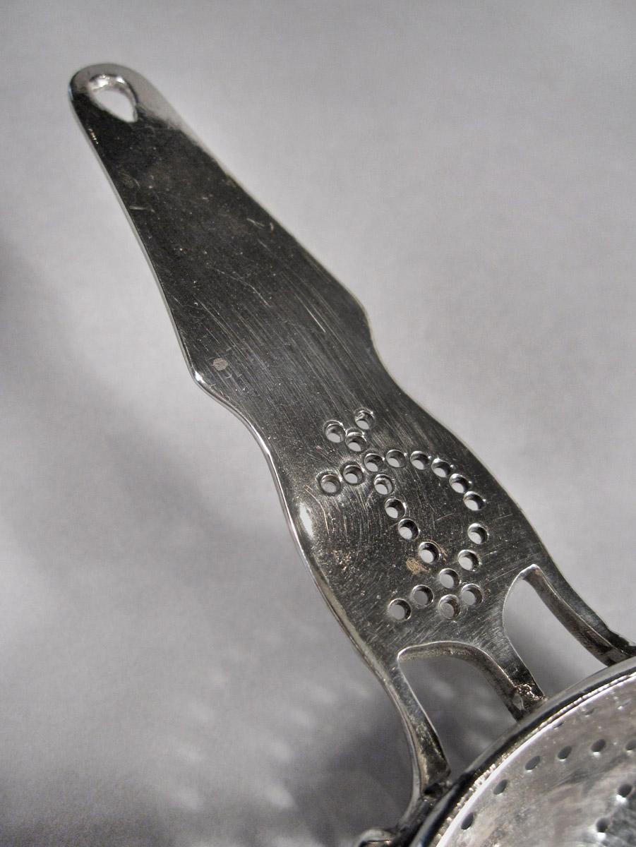 1957.0829 Strainer, detail 1