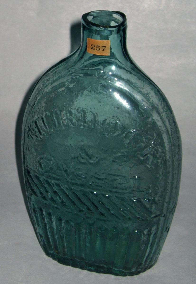 1975.0192 (side 2) Glass historical flask