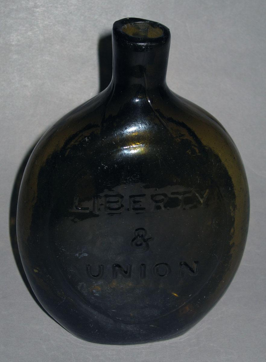1975.0193 Glass bottle (side 2)