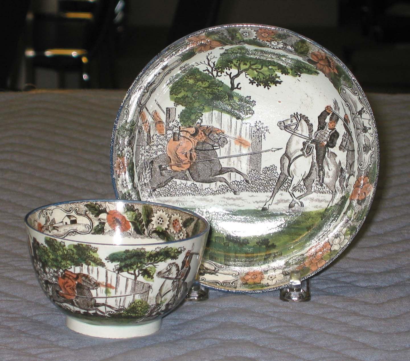 1979.0044 A, B Pearlware teabowl and saucer with printed military scene