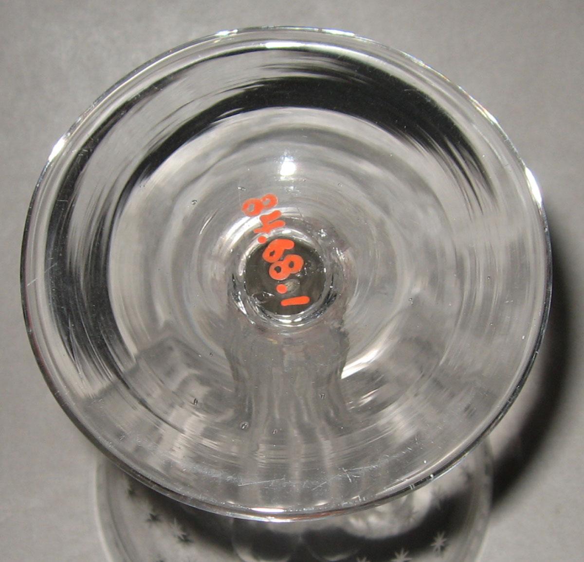 1984.0068.001 Colorless glass champagne glass (underside)
