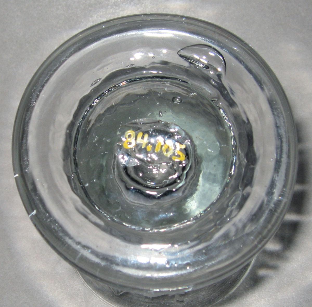 1984.0105 Colorless glass firing glass (underside)